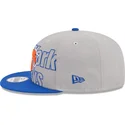 casquette-plate-grise-et-bleue-snapback-9fifty-draft-edition-2023-new-york-knicks-nba-new-era